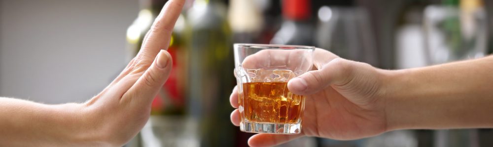 Female,Hand,Rejecting,Glass,With,Alcoholic,Beverage,On,Blurred,Background No to drinking